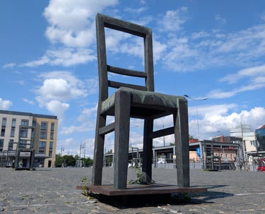 Empty bronze chair at Ghetto Heroes Square in Krakow, Holocaust memorial.
