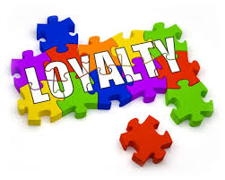 the word loyalty in white bold font puzzled together with rainbow pieces