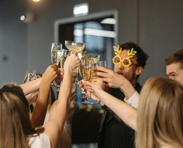 a group of people holding glasses of champagne