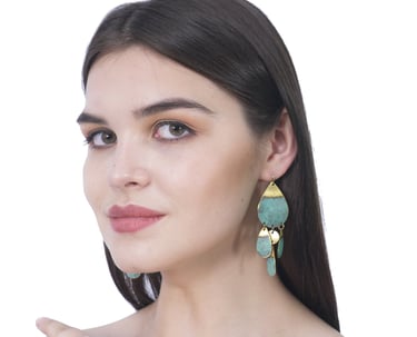 a woman wearing a green handmade patina wash earring