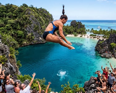 A female cliff diver jumps into a tropical blue lagoon surrounded by cheering crowds and palm trees.