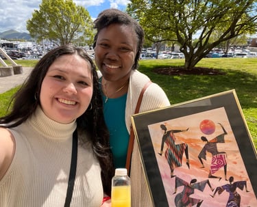 a woman holding a picture of a painting