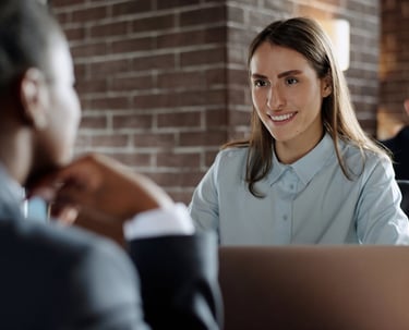 a woman in a blue shirt and a man in a suit and tie