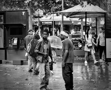 Peter Pickering, on Perth's streets, captures an exchange by two aboriginal men.
