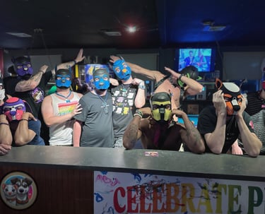 A group of men in a bar, posing in pup masks.