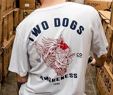 a man in a white shirt is standing in a warehouse