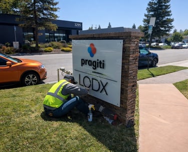 Technician installing monument sign panel for commercial property