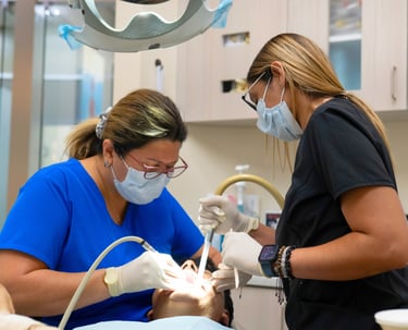Dental implant procedure performed by a dentist and assistant in a NYC dental office