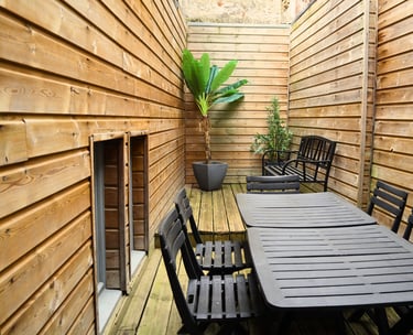 Terrasse privative avec table et chaises pour repas d’équipe en extérieur.