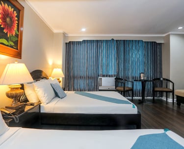 a hotel room with two beds and a couch