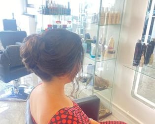 a woman sitting in a chair in Hair salon
