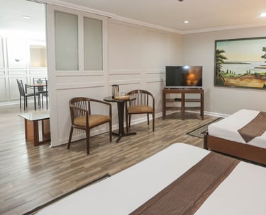 a hotel room with two beds and a television