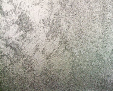 A cool silver paint sample showing off its shimmering grainy texture.