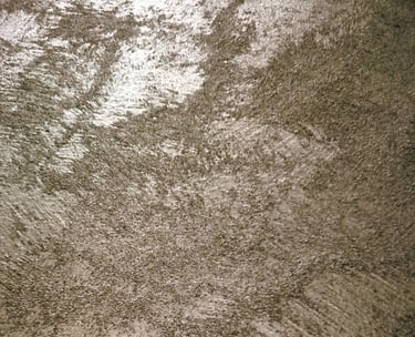 A warm silver paint sample showing its lustre and beautiful grainy texture.