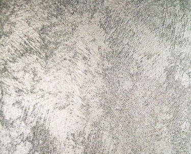 A cool silver paint sample showing off its shimmering grainy texture.