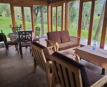 Seating area of a mountain homestay in Chikmagalur with a scenic view