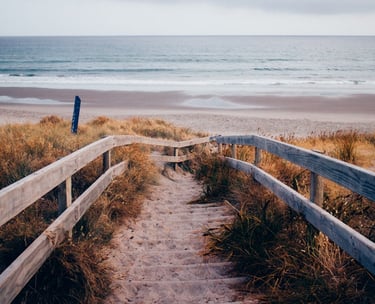 a wooden path leading to a beach