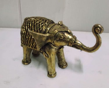 "Finely crafted brass baby elephant with raised trunk and ornate tribal motifs-For global distribution"