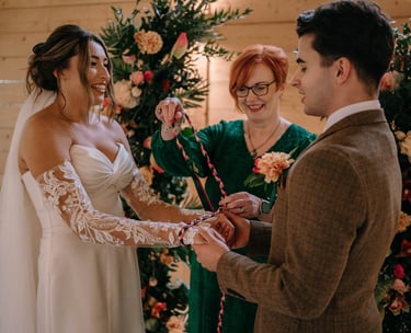 Celebrant leading a handfasting ceremony with a wedding couple