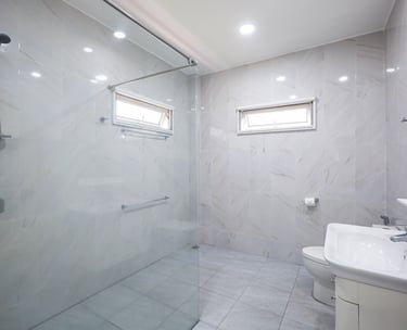 Spacious marble-style bathroom with a large walk-in shower.