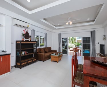 Spacious living room interior with dining area in One Bedroom Suite