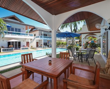 Private outdoor terrace with wooden dining table by the pool
