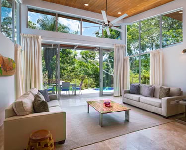 a living room with a couch and a table in this amazing Belize Villa
