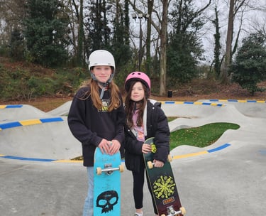 two girls holding a skateboard