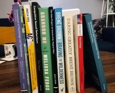 Collection of therapy books, textbooks, fiction, poetry.