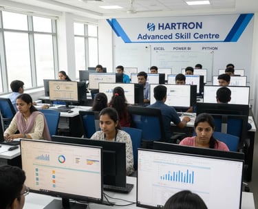 Students working on statistical data analysis with laptops and digital displays