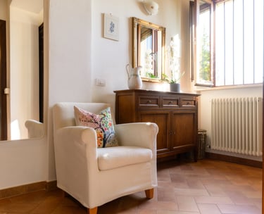 a chair with a pillow on it in a room