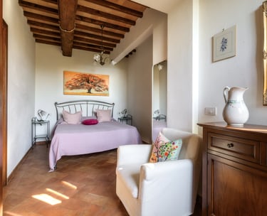 a bedroom with a bed and a chair