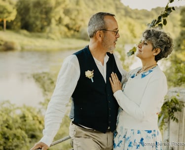 Elegant senior wedding couple gazing at each other by a river — fine art photography South of France