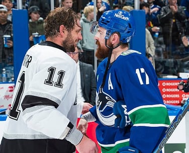 Filip Hronek of the Canucks congratulates Anze Kopitar of the Kings after his last NHL game in Vancouver, BC (Apr. 14/26)