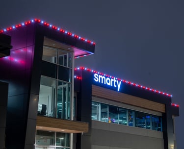 Red and white lights shining at night that are installed on a business 