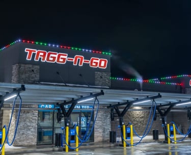 Christmas colored lights shining at night that are installed on a car wash