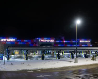 Red and blue lights shining at night that are installed on a car wash