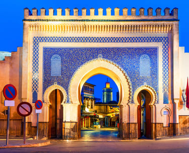 a building with a large archway and a blue sky
