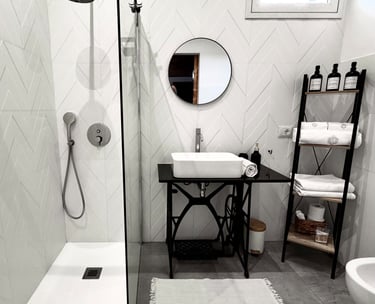 Modern bathroom with walk-in shower and elegant black fixtures in Sicily villa