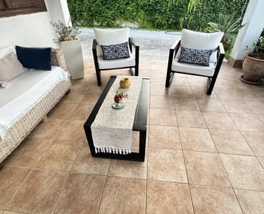 Cozy covered terrace with outdoor sofa and armchairs in beachfront villa Siracusa, Sicily
