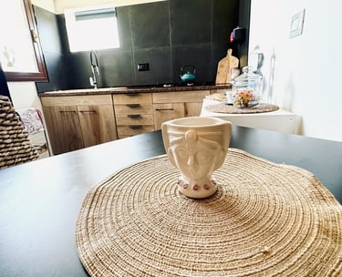 Rustic wooden kitchen with ceramic cup on dining table in seaside villa Siracusa, Sicily