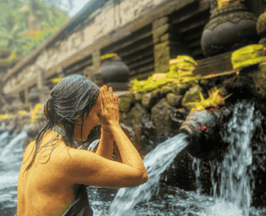 a woman in a bikini top standing in a river