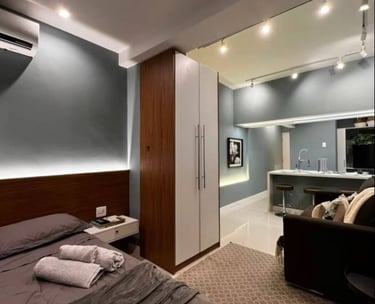 a bedroom with a bed, couch, and a couch