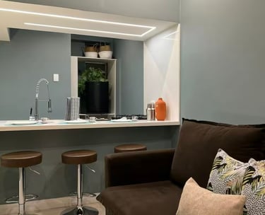 a living room with a couch and a bar stool
