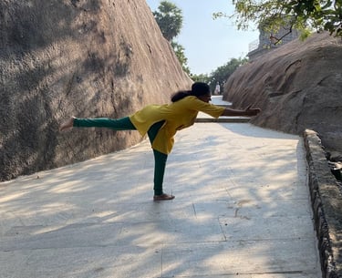 a woman in a yellow shirt is doing yoga
