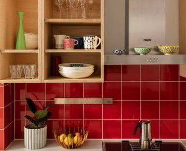 Close up of kitchen ply cupboards and red splashback