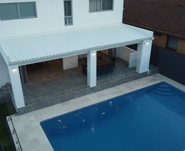 aerial shot white home with pool