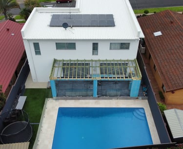 aerial shot white home with pool and patio in construction