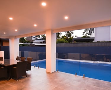 well lit tiled outdoor area with pool