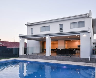 foreground pool with patio well lit outdoor entertainment